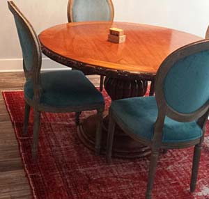 Red overdyed rug under table